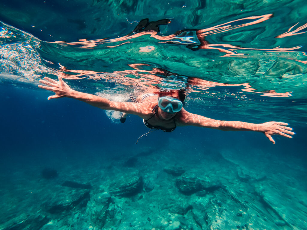 Underwater stock photo of woman snorkeling in the shallow sea water